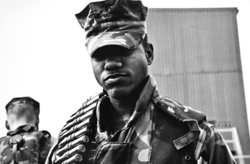 A young Lechon Kirb in Marine Corps camouflage utilities and cover, photographed in black and white